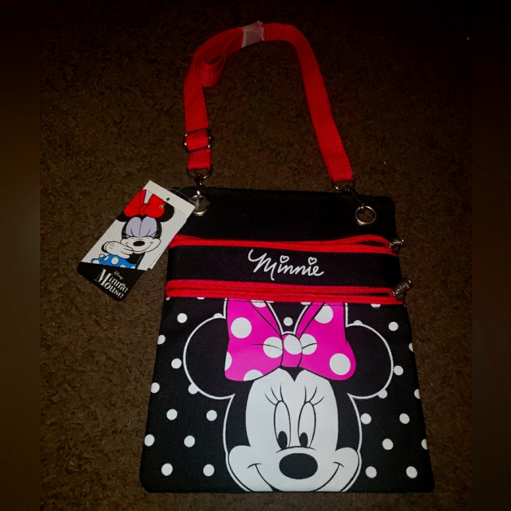 Two cross body purses. On Minnie Mouse cross body, and t a red cross body